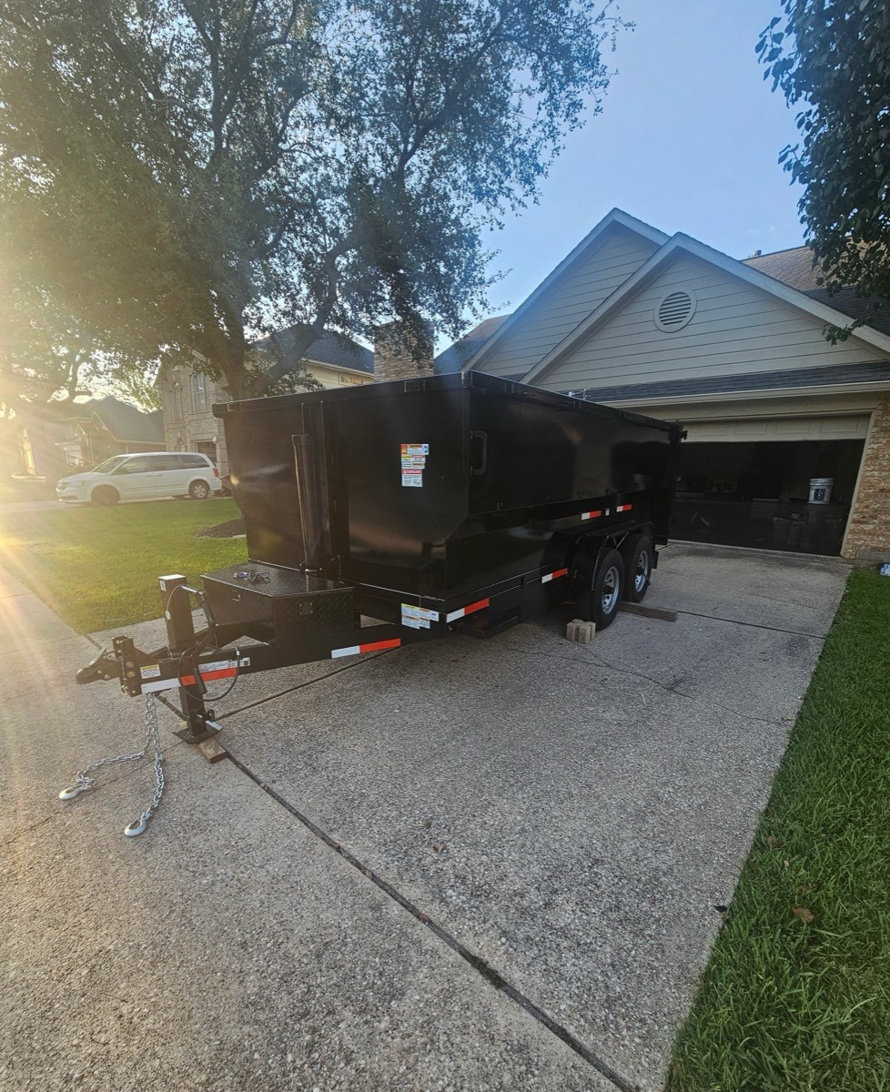 Dump trailer dropped in a residential driveway on protective boards