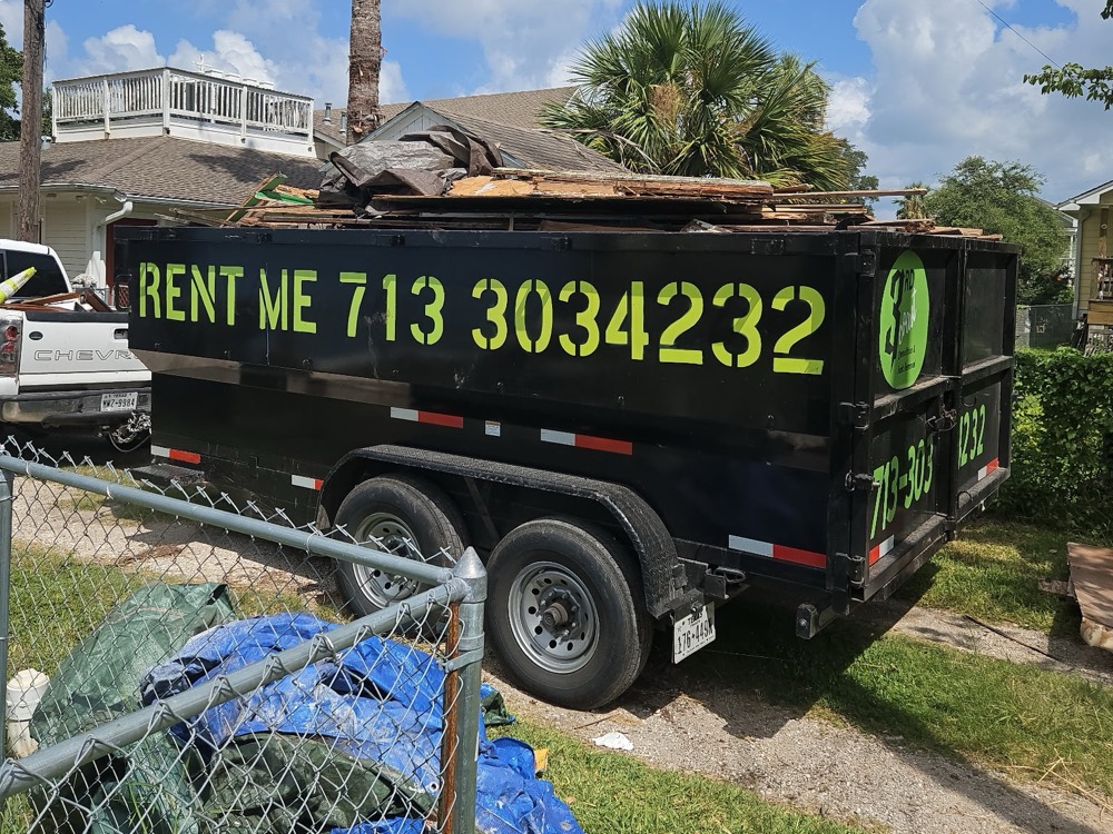 Dump trailer loaded high with demolition debris